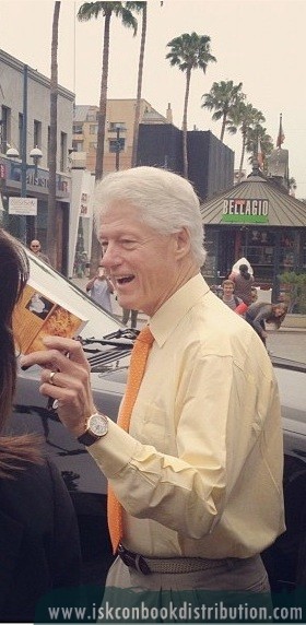 Bill Clinton Holding up the Bhagavad Gita